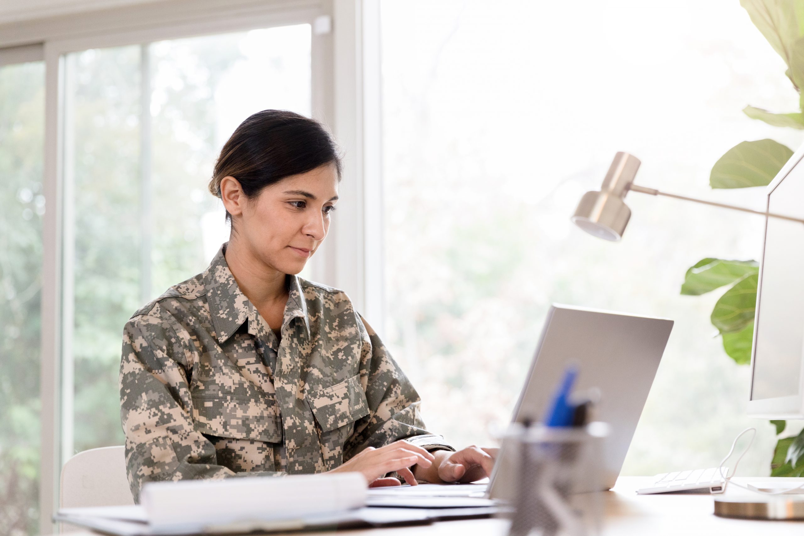 Female adult soldier voting remotely using Enhanced Voting.